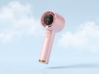 Frostbite mini turbo fan in soft pink, floating against a pale cloud sky
